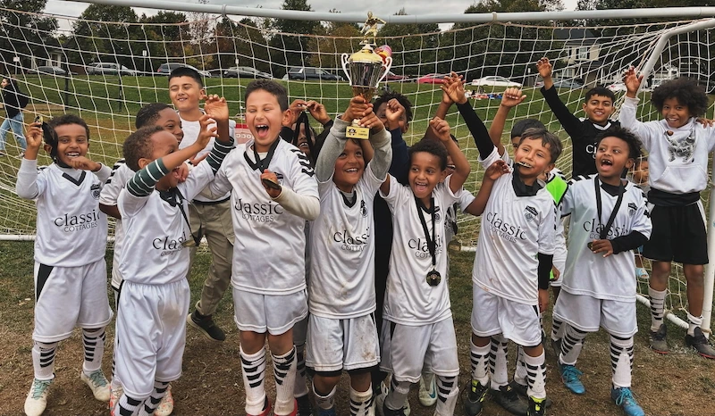 Young soccer players celebrating a goal with joy